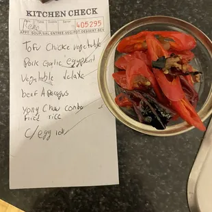 Paper from the delivery bag with no It mention of spice level. The peppers I removed from my mild dishes.