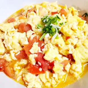 Tomato Eggs :  Eggs Garlic onions and tomatoes lightly boiled in broth. Great mixed in rice