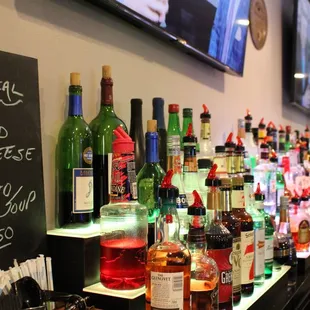 a row of liquor bottles on a bar