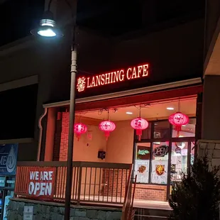 the front of the restaurant at night
