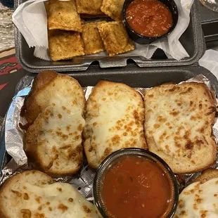 a tray of grilled cheese and tomato sauce