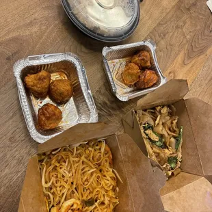 three take out containers of food on a table