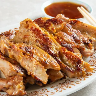a plate of grilled pork