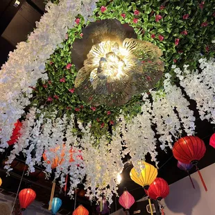a ceiling of flowers and paper lanterns