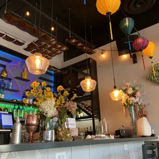a bar with flowers and vases