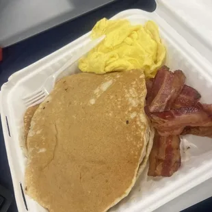 a breakfast of pancakes, bacon and eggs
