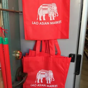 two red shopping bags with elephants on them