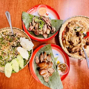 three plates of food on a wooden table