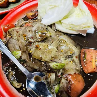 a bowl of soup with meat and vegetables