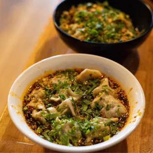 two bowls of food on a table