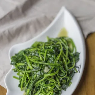 a plate of stir fried green vegetables