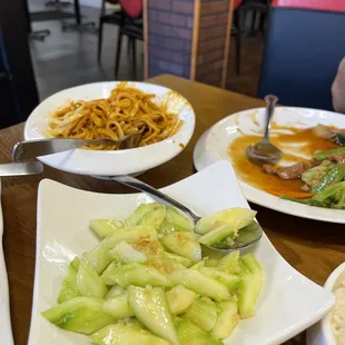 Dandan noodles (mostly eaten), garlic cucumbers )1/4 eaten), and beef and vegetables ( mostly already eaten)
