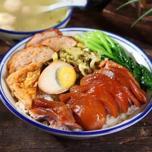 a bowl of rice with meat and vegetables