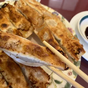 a plate of food with chopsticks