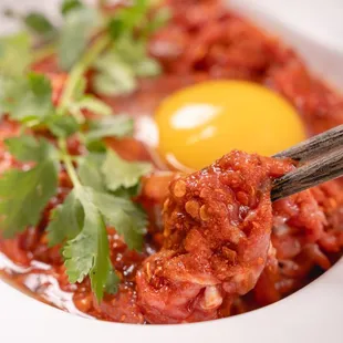 a hotpot with an egg on top