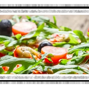 a salad with tomatoes and olives