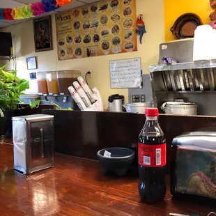 a table with a bottle of soda