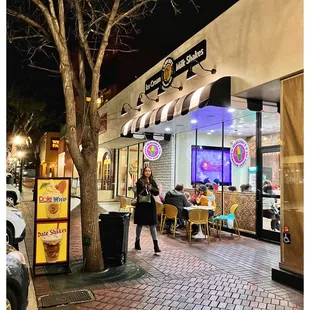 a woman standing in front of a store