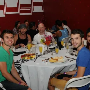a group of people sitting around a table