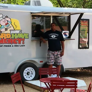 a man standing at a food truck