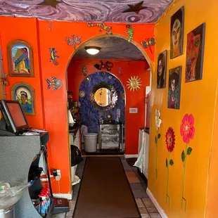 a brightly colored hallway leading to a bathroom