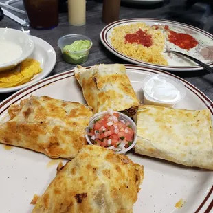 Burritos rancheros.  Inside has cheese, carnitas, chicken, onions peppers and chorizo. it was a lot of food . Very good flavor.