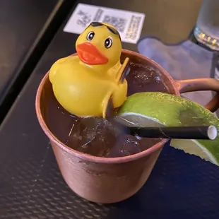 a rubber duck in a cup of liquid