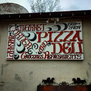 a pizza and deli sign
