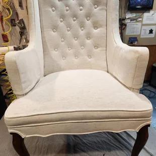 Vintage winged chair, white on white details.