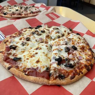 two pizzas on a table