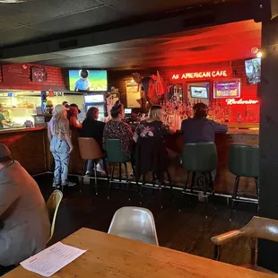 a group of people sitting at a bar