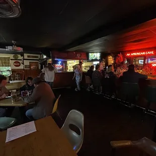 people sitting at tables in a restaurant