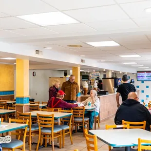 people sitting at tables in a restaurant