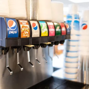 a row of soda dispensers