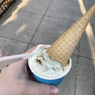 a hand holding an ice cream cone