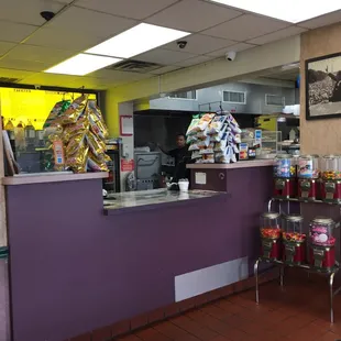 Counter with grill in back, not seen is side where they make pizzas