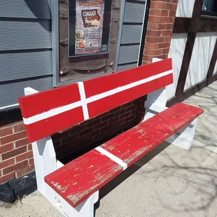 Sweet bench painted up like the Danish flag outside of the pub.