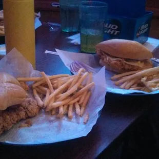 Two tenderloins with one shared orders of fries.