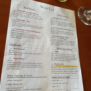a wine list and a glass of wine