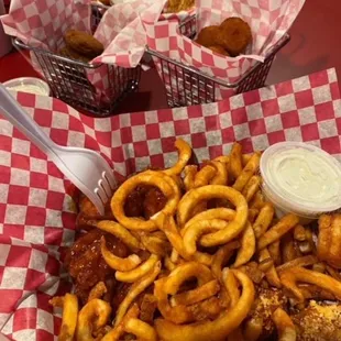 a basket of fried wings and onion rings