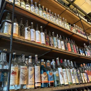 a shelf full of liquor bottles