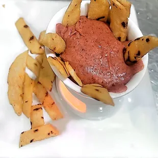 a bowl of dip and fries