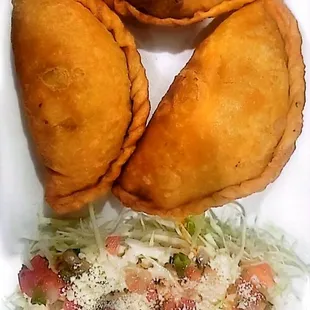 three empanadas on a plate