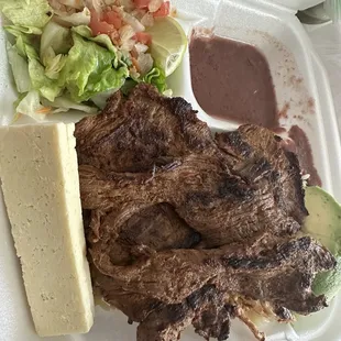 a plate of meat and a salad