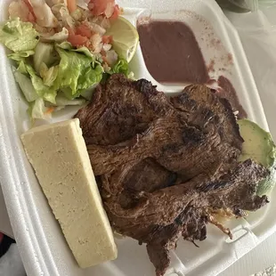 steak and salad in styrofoam container