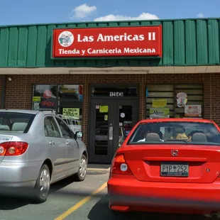 two cars parked in front of a mexican restaurant