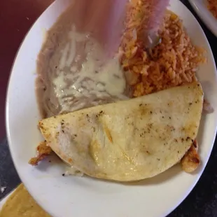 Kid quesadilla with the little guys hand going right in for the kill