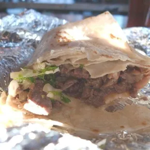 Carne Asada burrito (partially eaten)