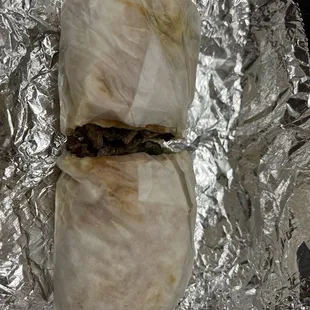 two burritos wrapped in aluminum foil