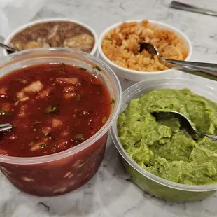 Sides of beans and rice. Half pint guacamole. Full pint salsa. Side of salsa is fresher than the little complimentary containers.